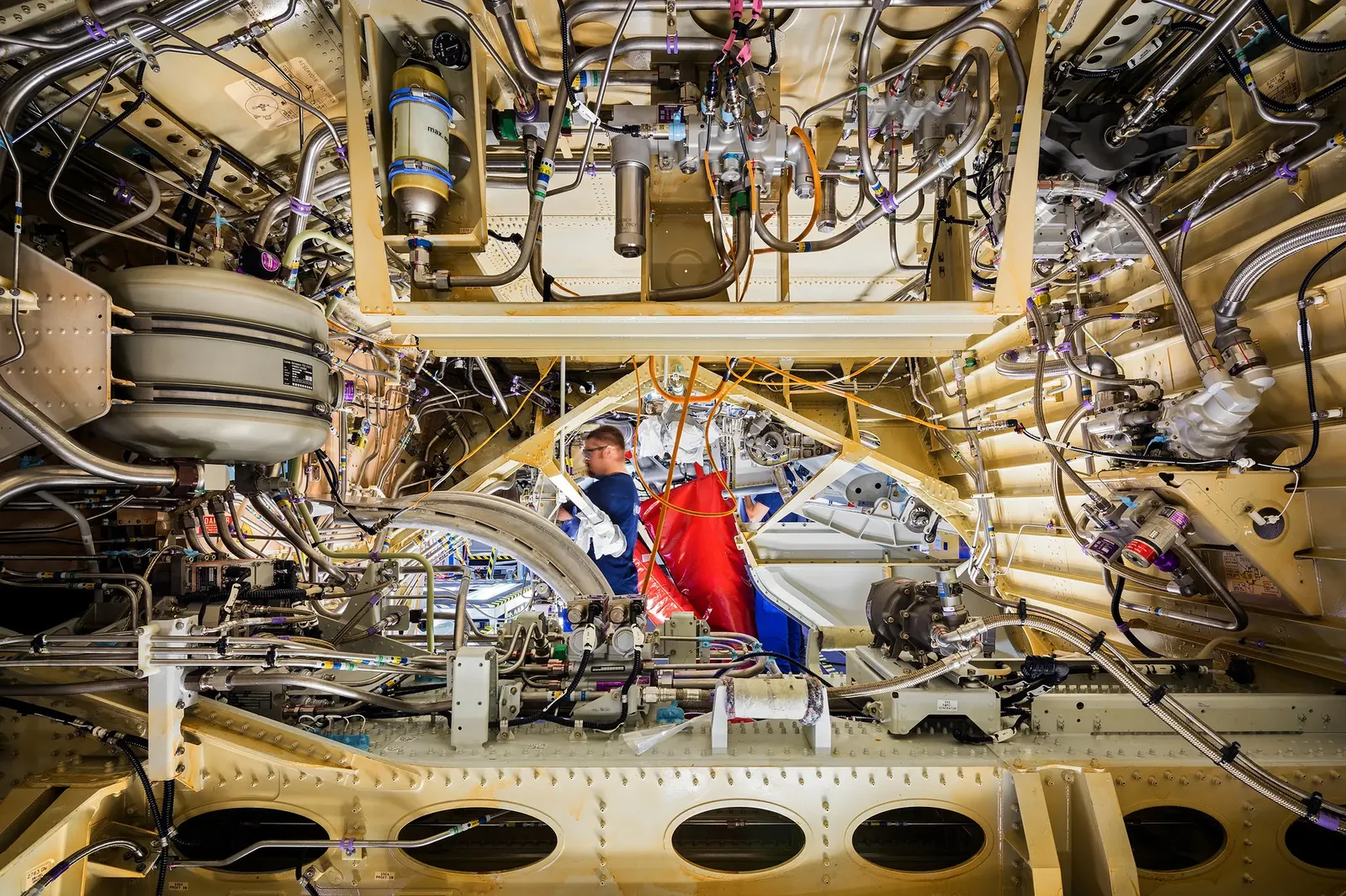 Fluid lines and fittings routed through an aircraft structure