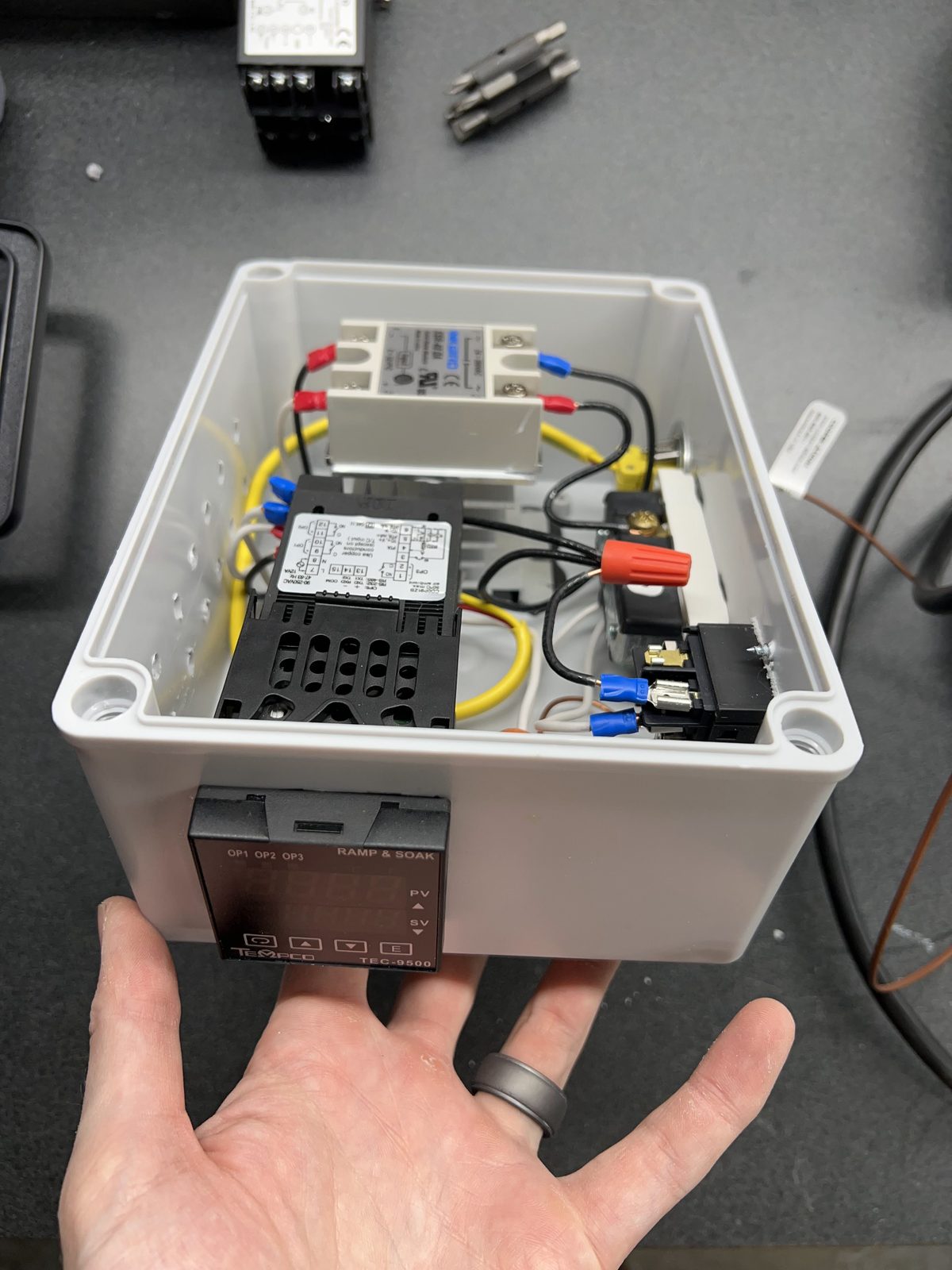 PID controller, solid-state relay, and wiring in the enclosure I built for the bench